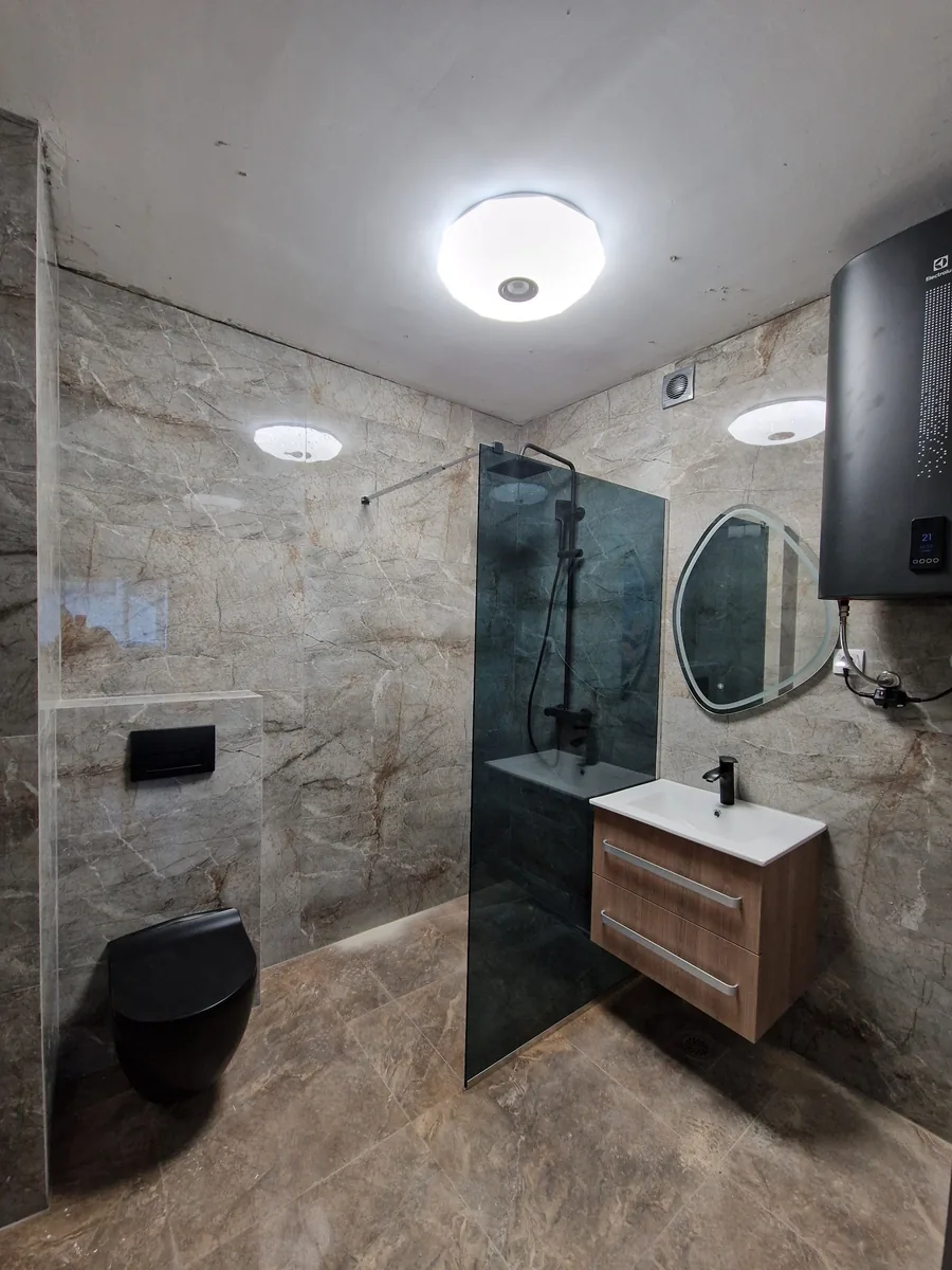 Smoked glass shower - ICONIC Real Estate
